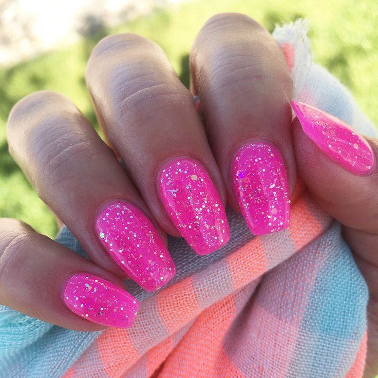 Glamorous Vibrant Pink Nail Design with Glossy Finish and Glitter Accents for a Playful Summer Look