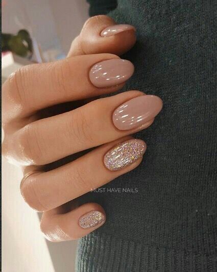 Chic Nude Nail Design with Sparkling Accent for Versatile Elegance.