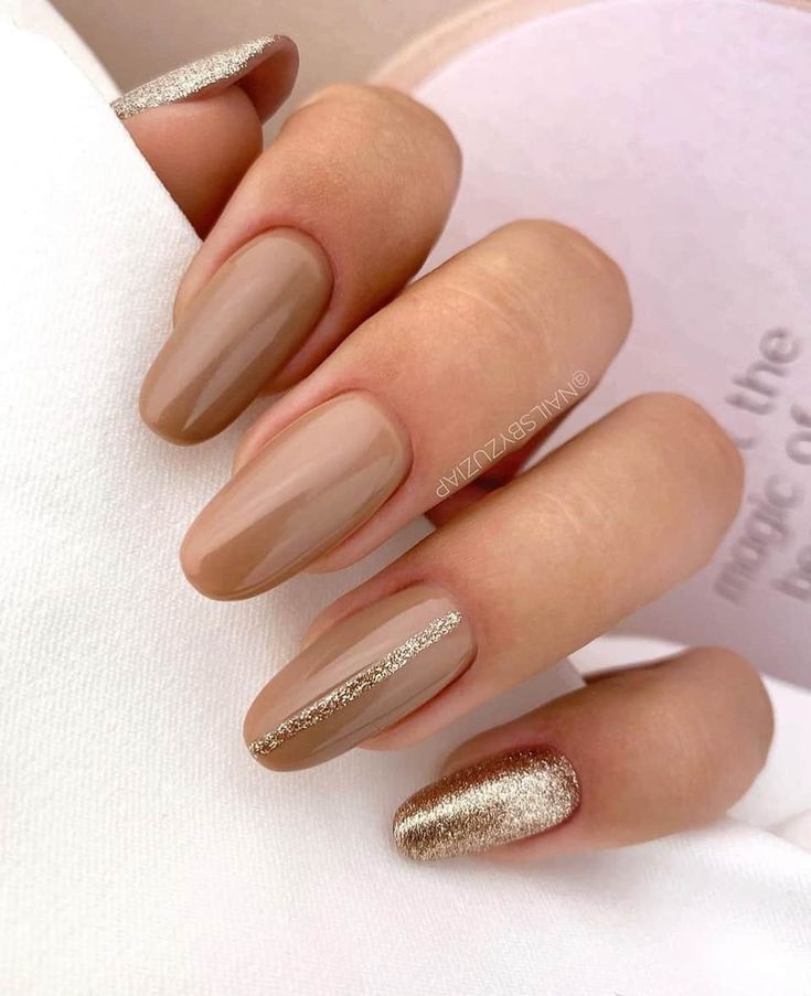 Sophisticated Almond-Shaped Nail Design with Soft Nude and Shimmering Metallic Accents.