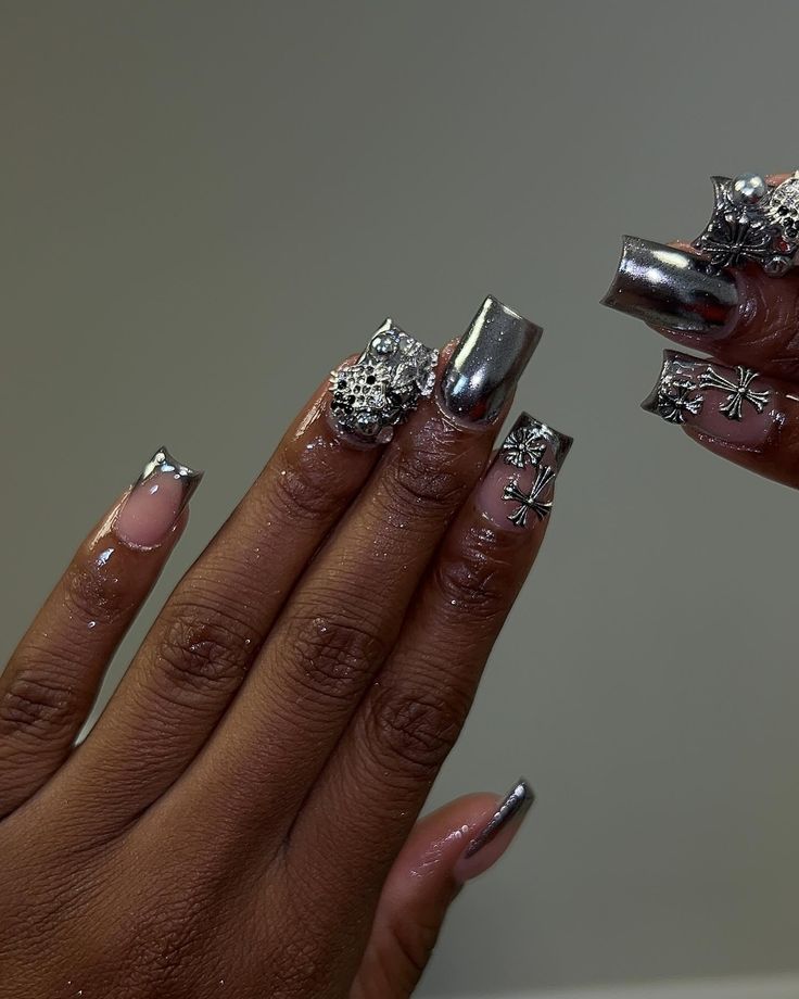 Chic Metallic and Nude Nail Design with Rhinestones and Geometric Accents.