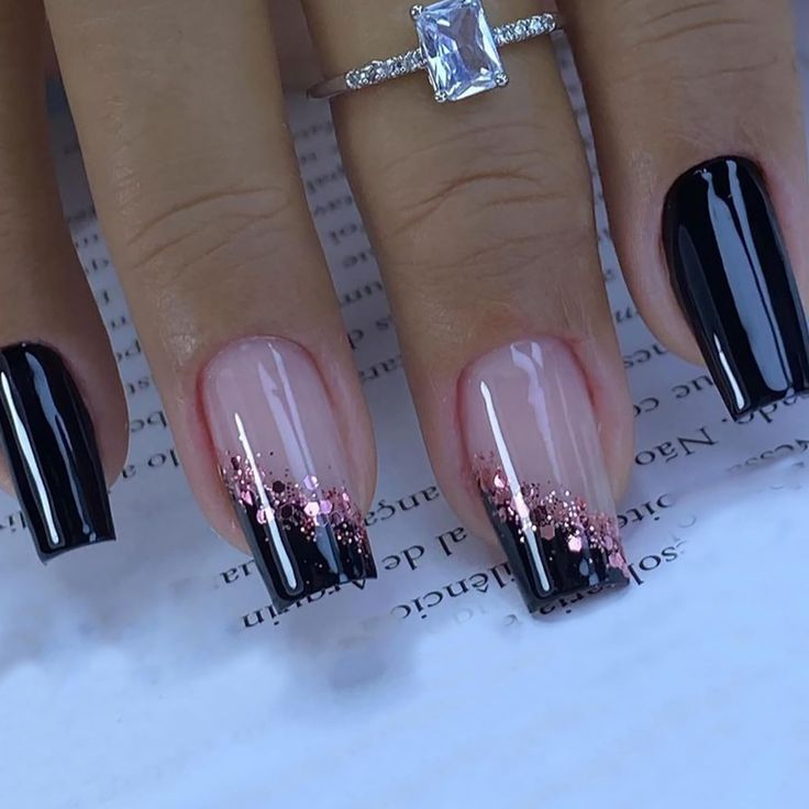 Chic Glossy Black and Nude Gel Nail Design with Rose Gold Glitter Accents.