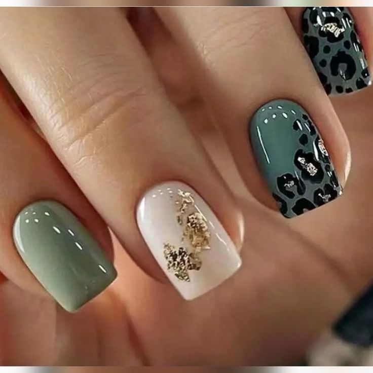 Elegant Nail Design: A Playful Mix of Colors, Patterns, and Gold Accents.