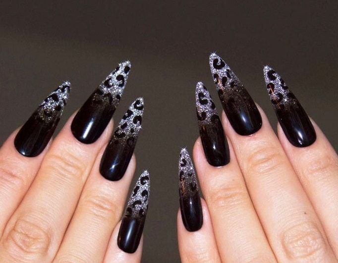 Elegant Bold Stiletto Nails: Striking Black to Shimmering Silver Gradient with Intricate Luxury Designs.