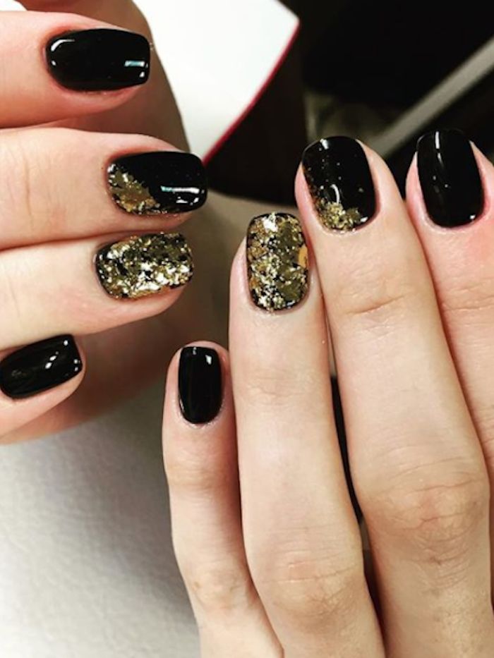 Chic Black Nail Design with Shimmering Gold Accents: Glamorous Versatility for Any Occasion.