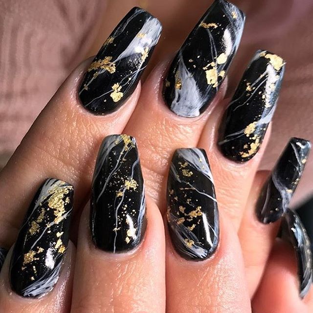 Luxurious Black Marble Nail Design with Striking Gold Flakes and Swirling White Accents