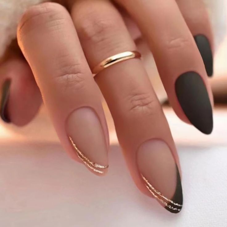 Chic Nail Design: Matte and Glossy Black and Nude with Elegant Gold Accents.