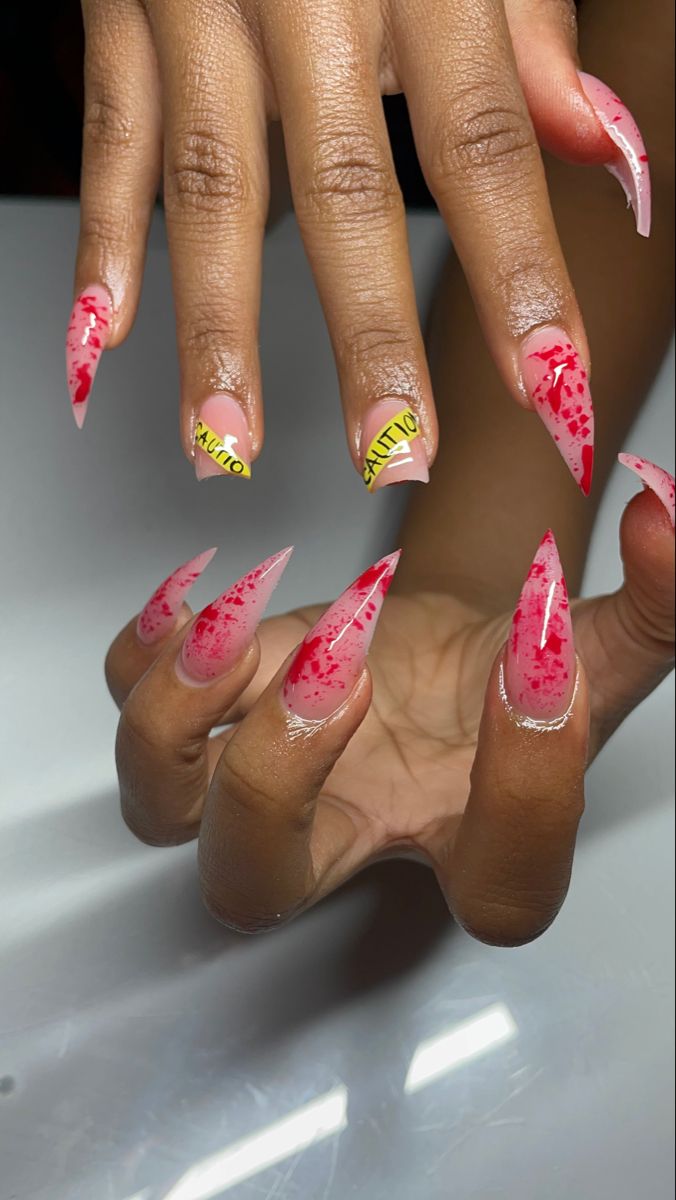 Edgy Vivid Nail Design: Long Pointed Tips with Pink-Red Gradient and Bold Accents