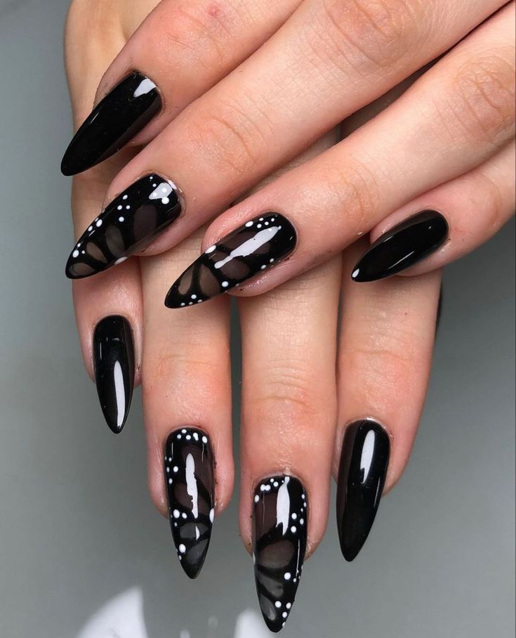 Bold Black Nail Design with Glossy-Matte Finish and Elegant Patterns.