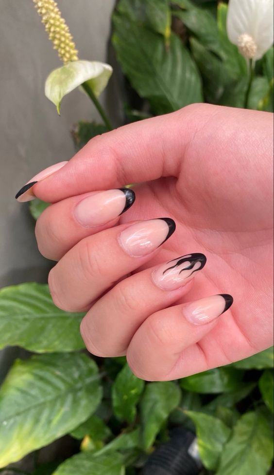 Elegant Nail Design Blending Natural Nude with Bold Black Flames.