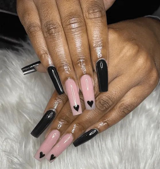 Chic Matte Black and Soft Pink Nail Design with Heart Accents.