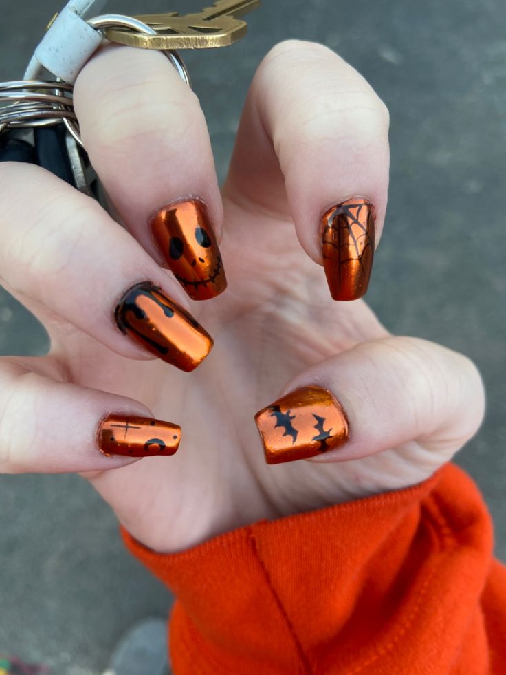 Playful Halloween Nail Design: Vibrant Orange Base with Glossy Black Spooky Motifs.