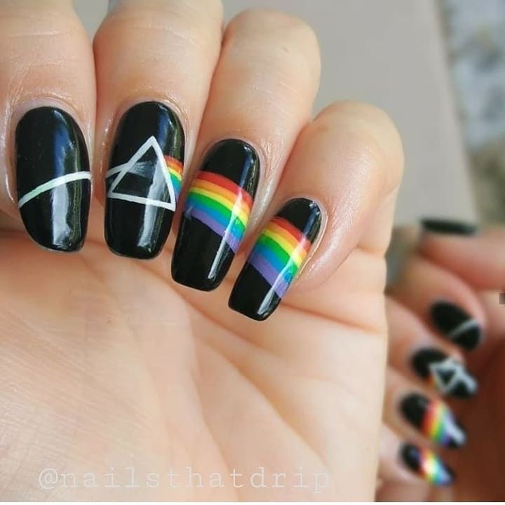 Bold Black Nail Design with Geometric White Accents and Vibrant Rainbow Stripes Celebrating Individuality.