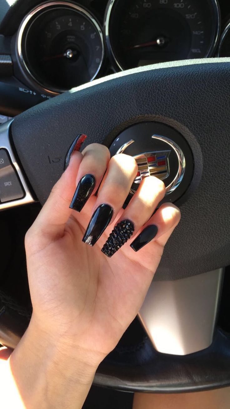 Elegant Black Nail Design: A Bold Mix of Glossy, Textured Elements with Glamorous Rhinestone Accents.