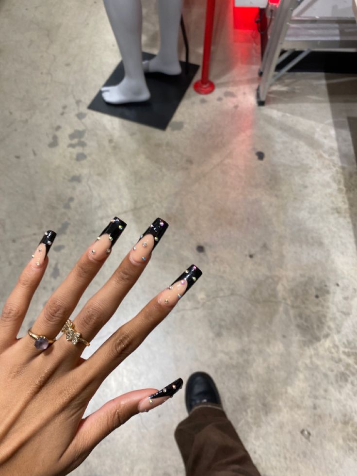 Chic Black Nail Design with Artistic Accents on Long Square Tips