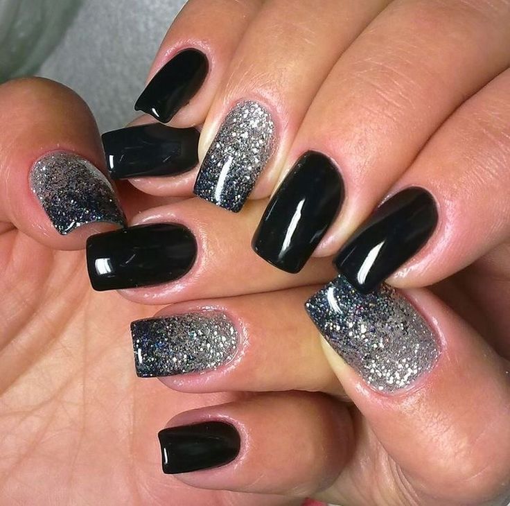 Sophisticated Ombre Nail Design: Glossy Black and Sparkling Silver Glitter.