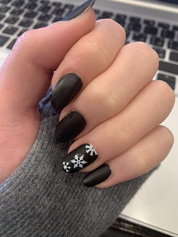 Chic Winter-Inspired Black Matte Nails with Festive Silver Snowflake Accents