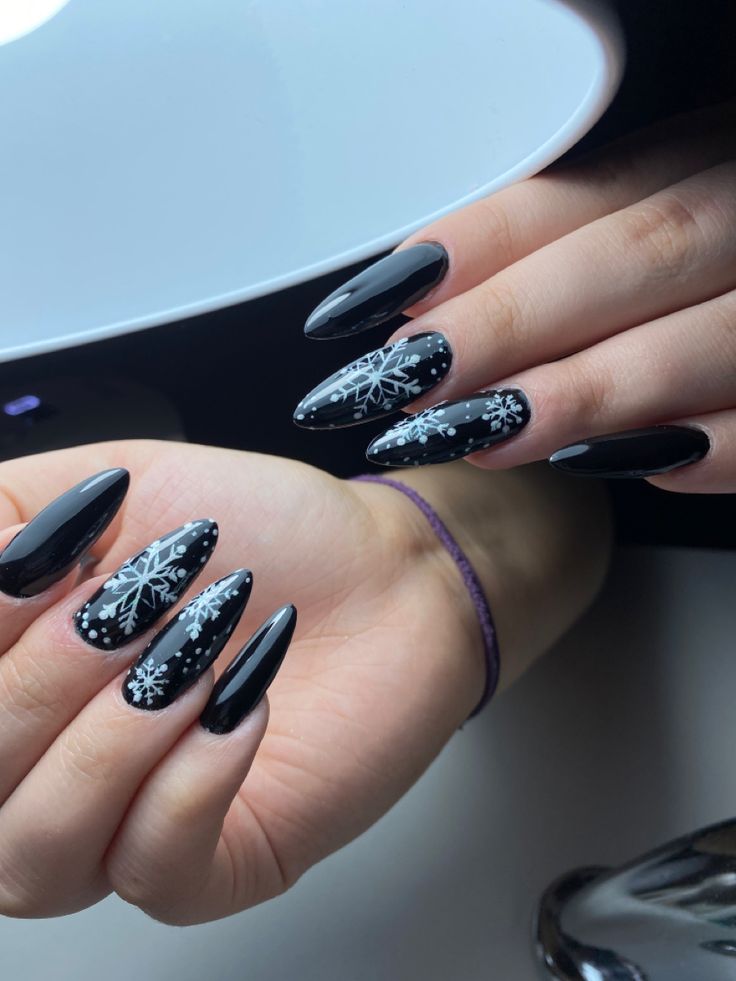 Sophisticated Winter-Themed Manicure: Elegant Black Nails with Intricate White Snowflakes