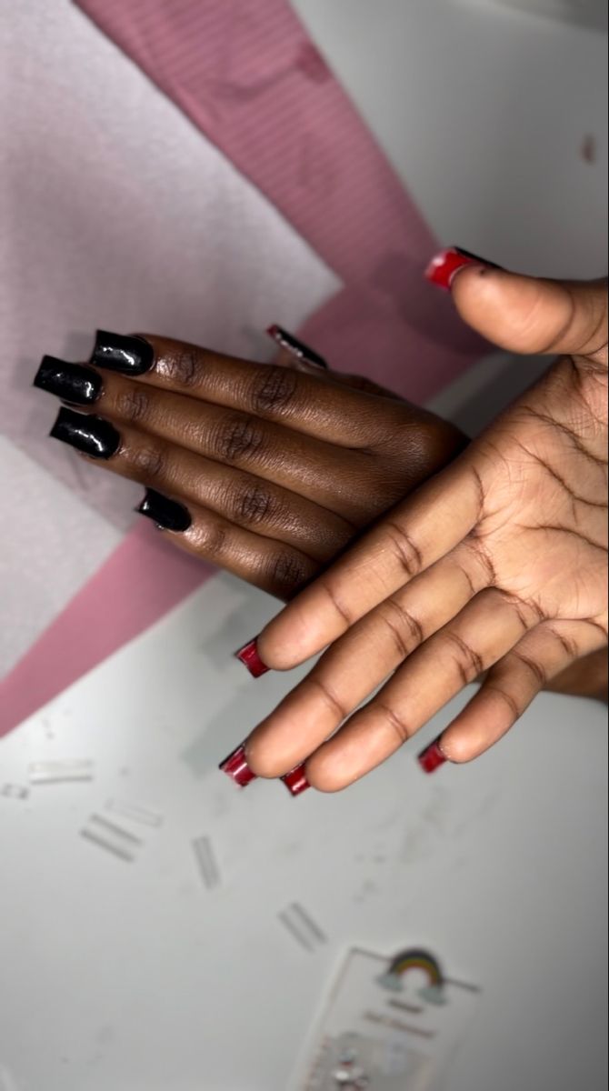 Bold Nail Art: Striking Contrast of Glossy Black and Vibrant Red Finishes.