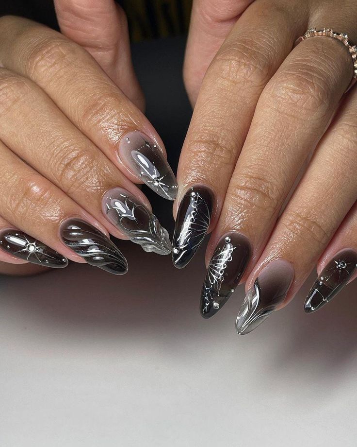 Sophisticated Nail Design with Black, Gray, and Clear Colors Featuring Intricate Patterns.