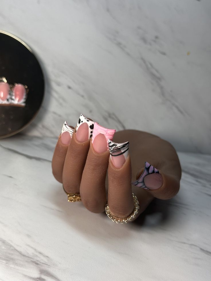 Vibrant Nail Design: Chic Pink, White, and Black Patterns with Playful Stripes and Abstract Shapes.