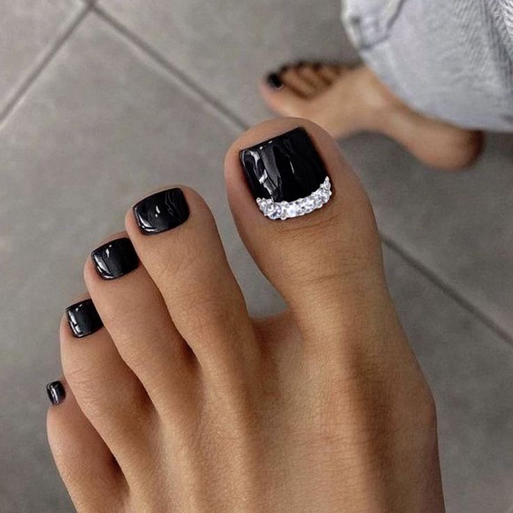 Chic Black Pedicure with Glossy Finish and Rhinestone Accent.