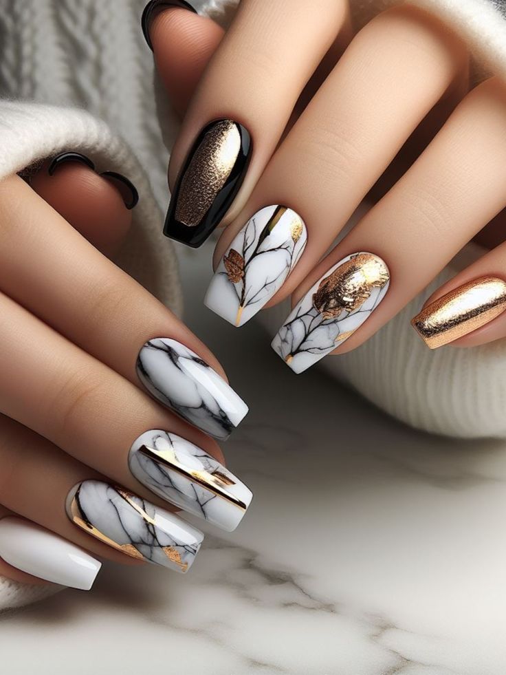 Sophisticated Nail Design with Matte Black, Metallic Gold, and Marbled White Finishes Featuring Intricate Patterns and Gold Leaf Accents.