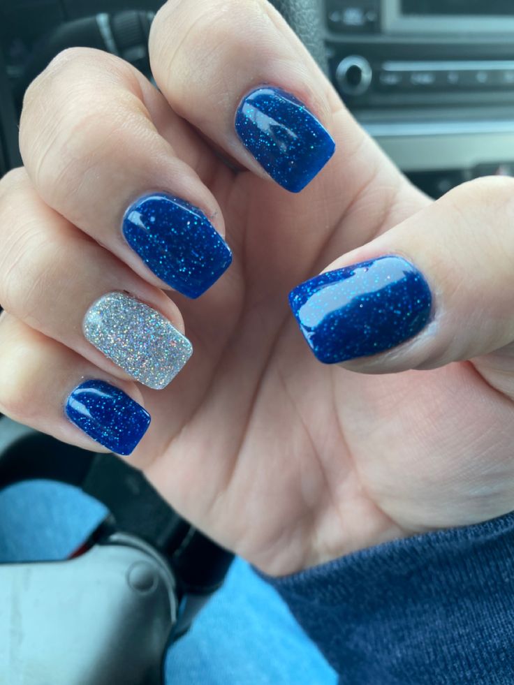 Stylish Nail Design: Deep Blue and Shimmering Silver with Glitter Accent