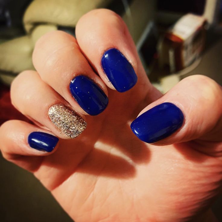 Bold Blue Nails with Glittery Gold Accent: Perfect for Any Occasion.