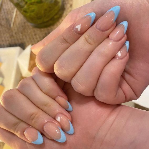 Charming Nude and Pale Blue Nail Design with Heart Accents for Every Occasion.