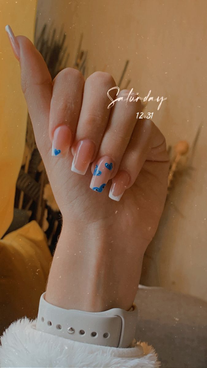 Elegant Chic Nail Design: Classic French Tips with Playful Blue Heart Accents