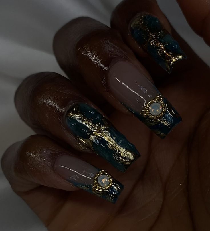 Sophisticated Nail Art: Matte Taupe and Glossy Teal with Gold Patterns and Rhinestones.