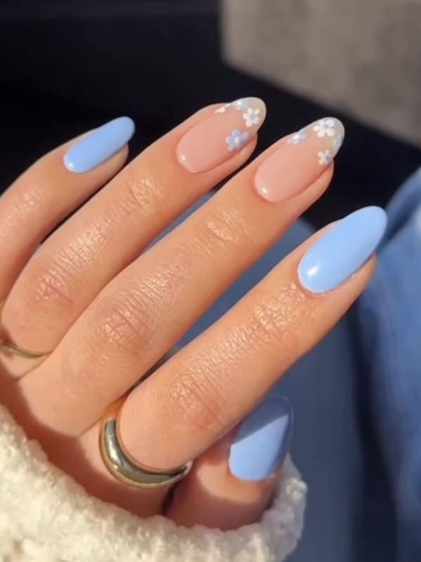 Elegant Pastel Blue and Nude Nail Design with Floral Accents for a Modern Feminine Look.