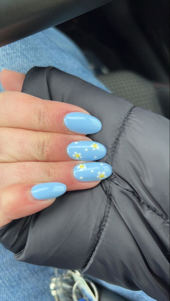 Spring-Inspired Soft Blue Nail Design with Delicate White Flower Accents.