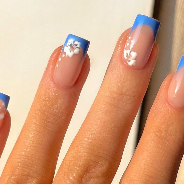 Elegant Floral Nail Design with Gradient Blue Tips for a Fresh Summer Look.