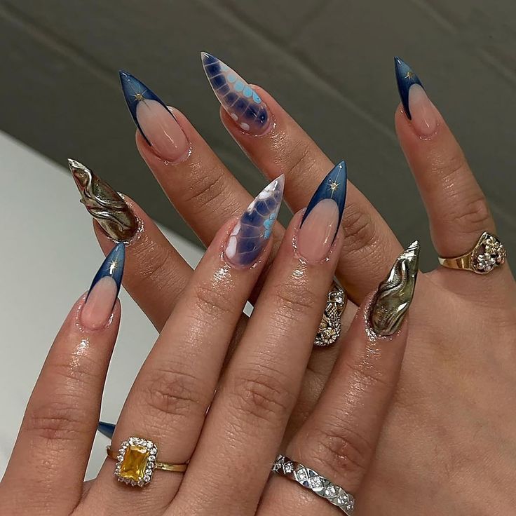 Modern Stiletto Nail Design with Blue Tips, Iridescent Effects, and Metallic Accents