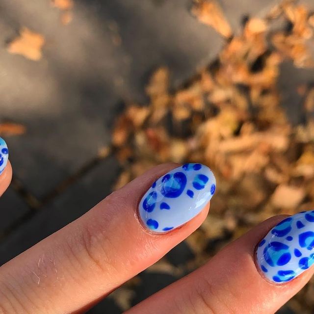 Whimsical Soft Blue Nail Design with Playful Spots for a Casual Look.