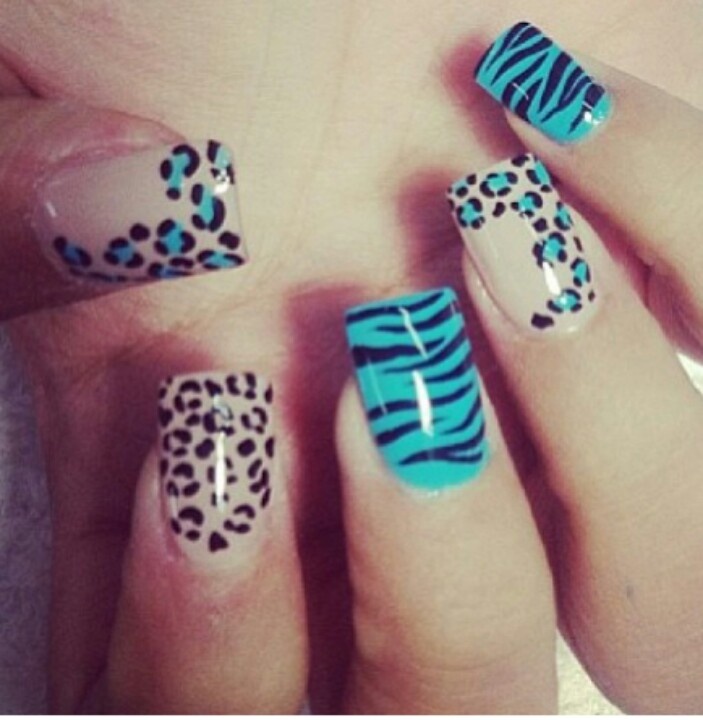 Vibrant Animal Print Nail Design: Bold Turquoise and Black Leopard-Tiger Patterns on a Nude Base.