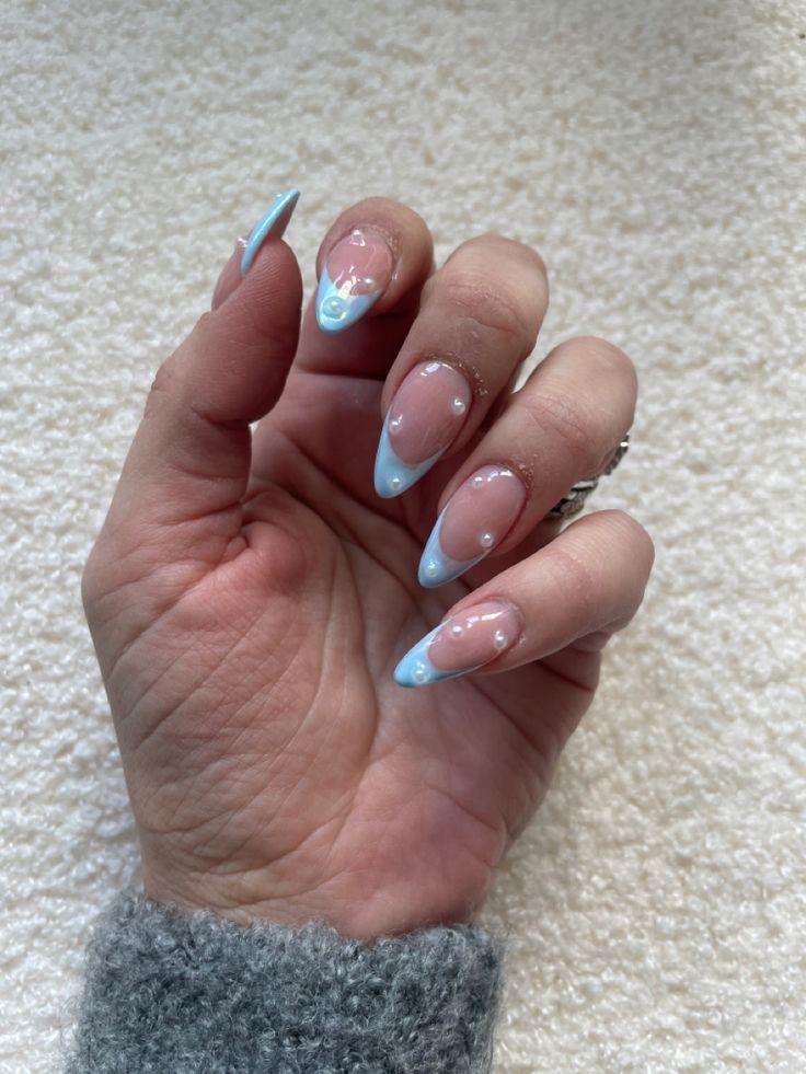 Chic Almond-Shaped Ombre Nail Design in Soft Nude and Pastel Blue.