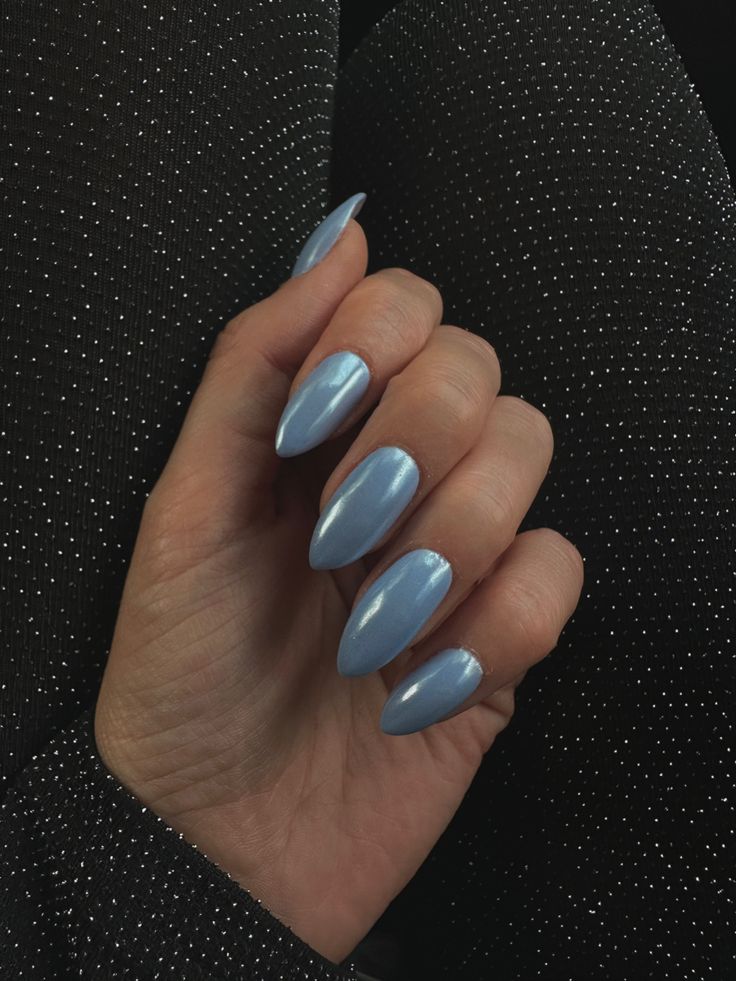 Sophisticated Baby Blue Almond Nails with Glossy Finish on Sparkly Black Background.