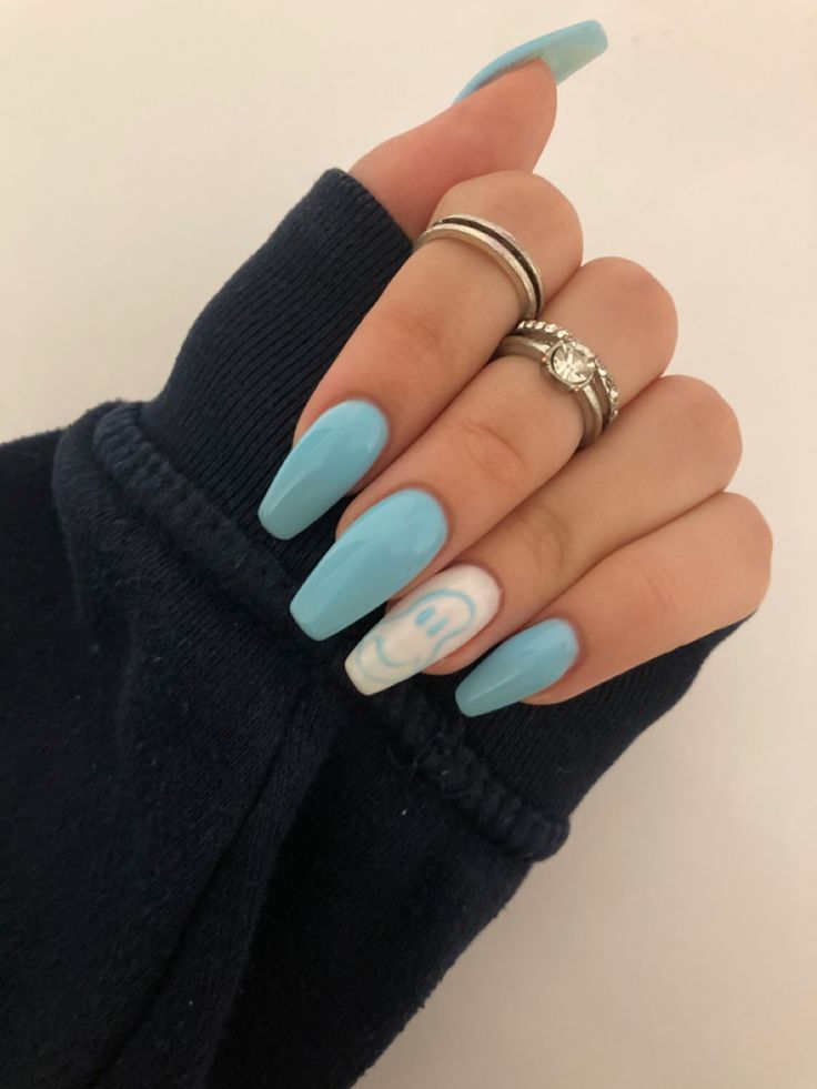 Whimsical Soft Blue Acrylic Nails with Cartoon Smiley Face and Delicate Rings