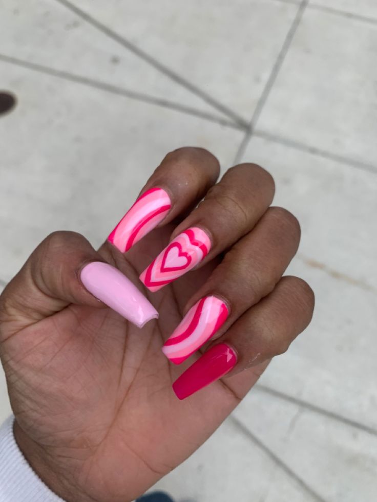 Playful Pink Nail Design with Stripes and Hearts for Creative Flair.