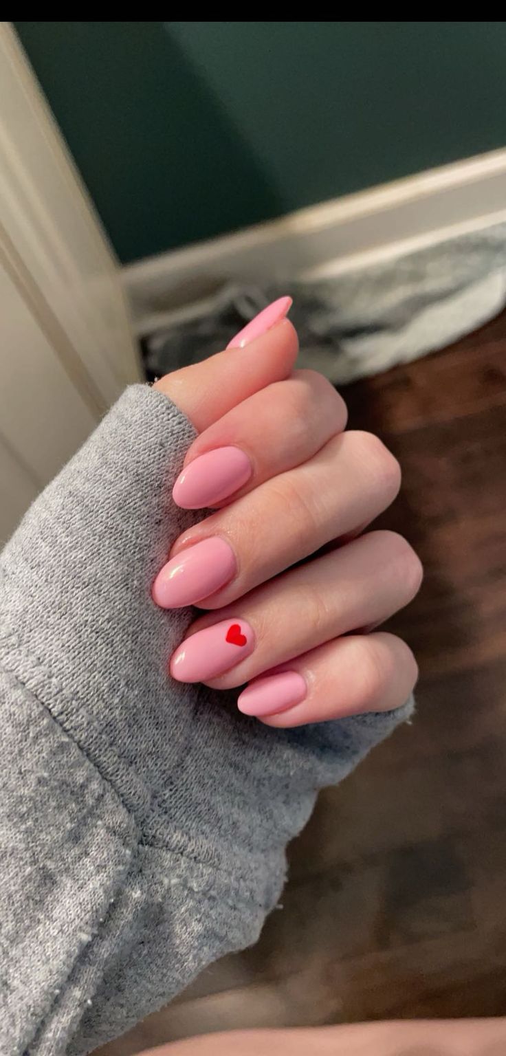 Chic Pink Nail Design with Playful Red Heart Accent