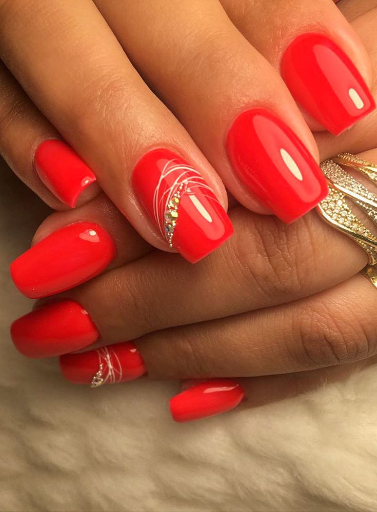 Chic Vibrant Red Nail Art with Glossy Finish and Glamorous Accents.