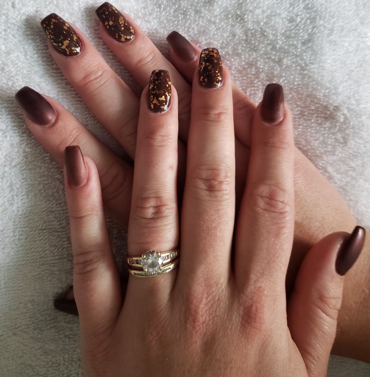 Sophisticated Nail Design: Rich Brown Matte with Glossy Glitter Accents and a Statement Ring.