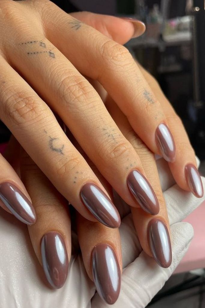 Sophisticated Almond-Shaped Nails with Glossy Taupe Finish and Subtle Finger Tattoos