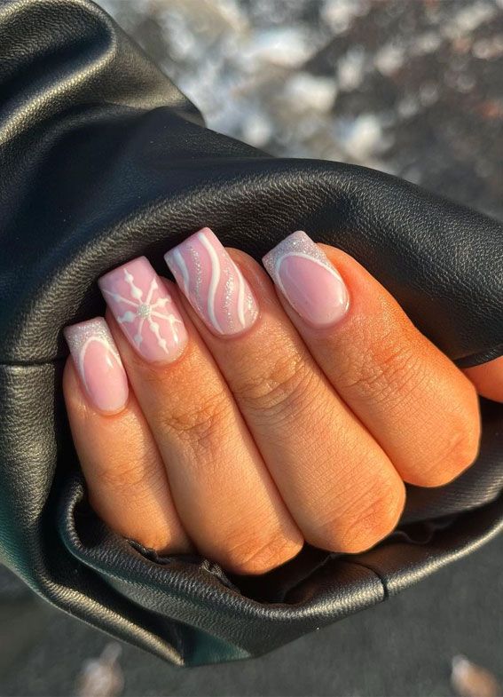 Elegant Winter-Inspired Nail Design with Soft Pink Base and Intricate White Patterns