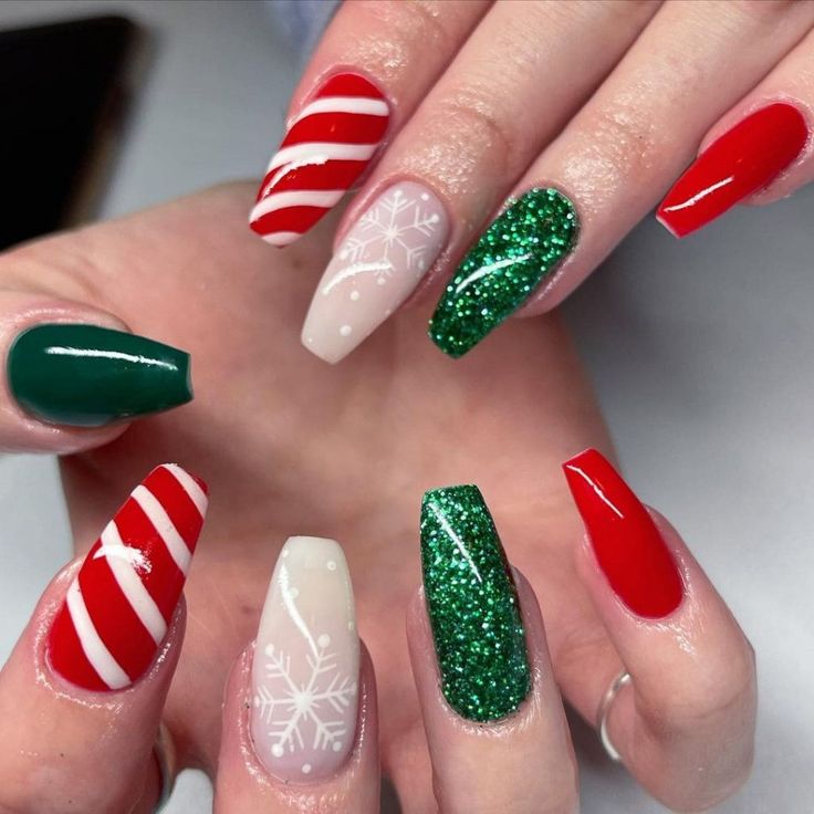 Vibrant Festive Nail Design with Candy Cane Stripes, Glitter, and Snowflakes for Celebrations.