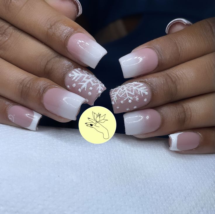 Chic Winter Nail Design: Soft Pink Gradient with Festive Snowflake Accents