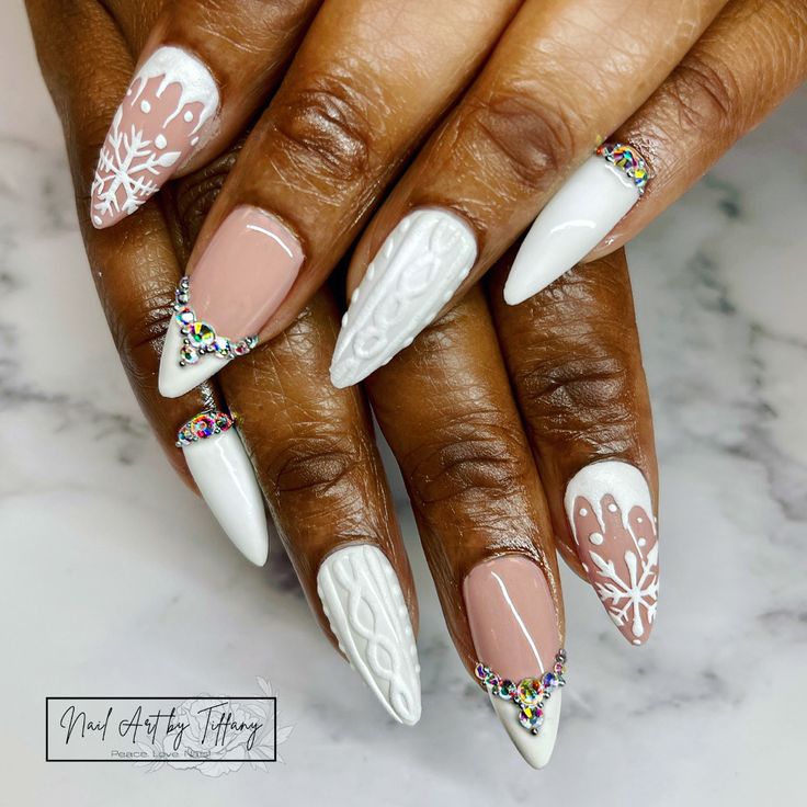 Chic Seasonal Nail Design: Matte White and Soft Pink with Winter Patterns and Rhinestone Accents.