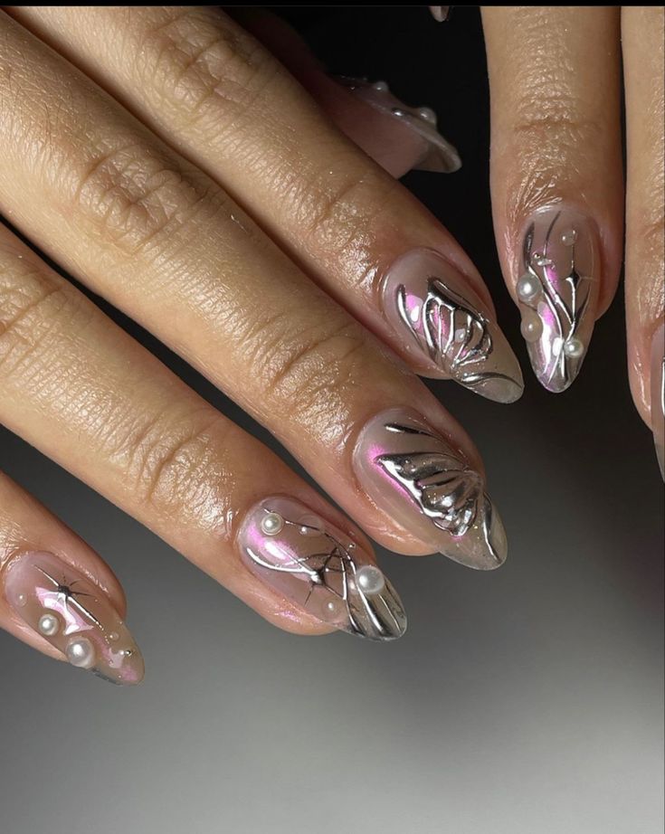 Chic Elegant Nail Design: Sheer and Metallic Finishes with Floral Patterns and Pearl Accents.